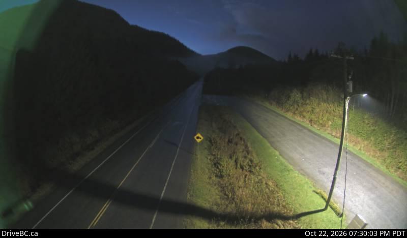 DriveBC camera: Highway 16 about 34 km east of Prince Rupert near McNeil River at the Rainbow Summit chain-up area, looking west.